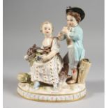 A GOOD MEISSEN PORCELAIN GROUP OF A YOUNG BOY AND GIRL, the boy playing a pipe, the girl seated with