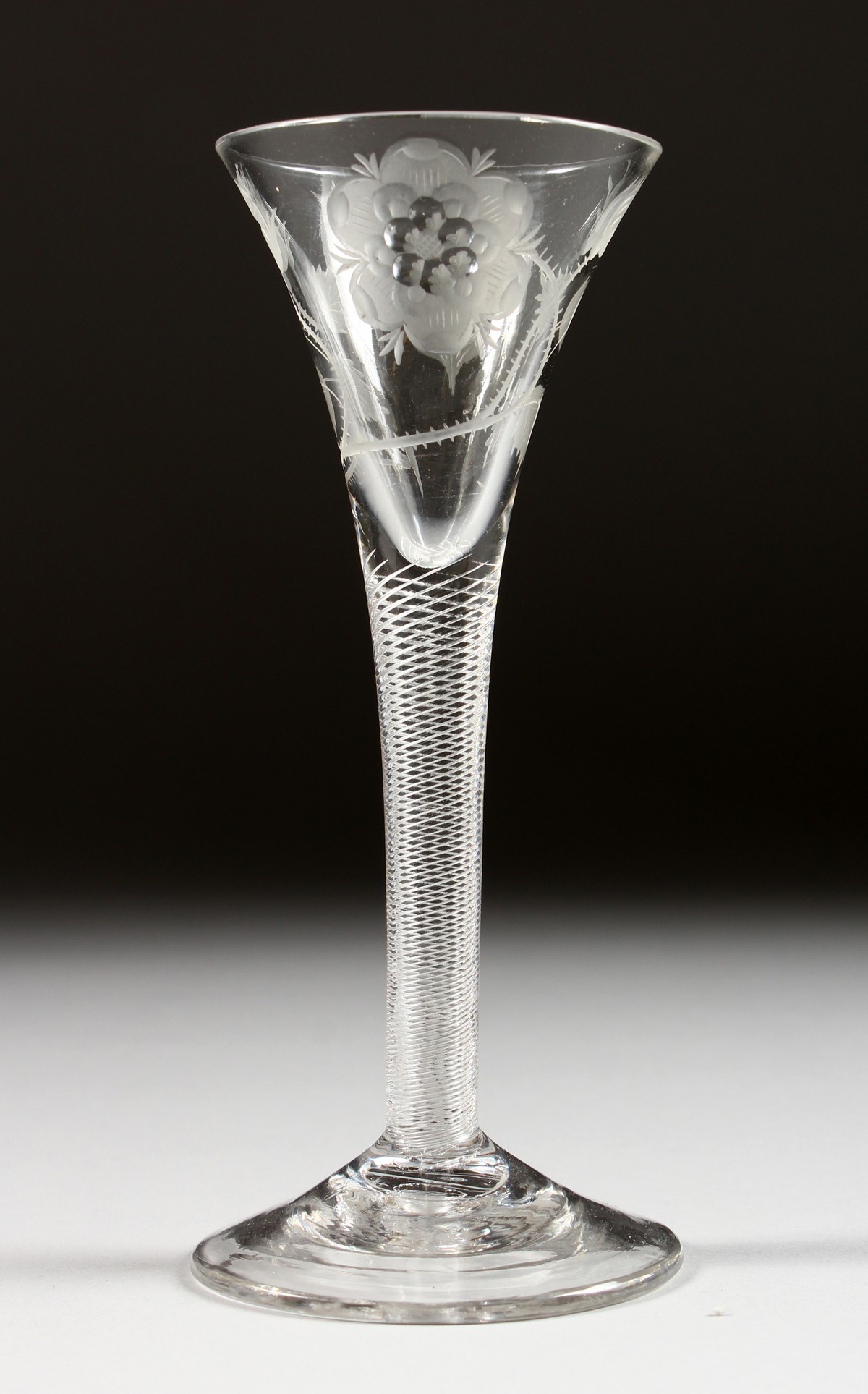 A VERY GOOD JACOBITE WINE GLASS, the trumpet bowl engraved with a rose and leaves, with an air twist