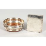 A CIRCULAR WINE COASTER AND A SILVER CIGARETTE BOX.