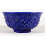 A DARK BLUE GROUND CHINESE BOWL with moulded decoration. 6ins diameter.