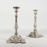 A PAIR OF CONTINENTAL SILVER CANDLESTICKS repousse with scrolls and shells. 9.5ins high. Weight