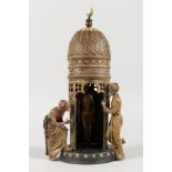 A VIENNA STYLE COLD PAINTED BRONZE GROUP of Arabs standing by a tower. 12ins high.