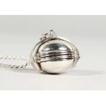 A SILVER FOLDING BALL LOCKET on a chain.