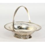 A GARRARD'S PIERCED OVAL SILVER BASKET with swing handle. London 1900.