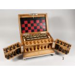 A SUPERB GAMES COMPENDIUM opening to reveal chess set, crib board, counters, cards etc. 13ins wide.