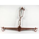 AN EARLY SPANISH WROUGHT IRON SET OF HANGING SCALES. 46ins wide x 36ins high.