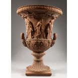 A GOOD TERRACOTTA TWO HANDLED GARDEN URN. 19ins high.