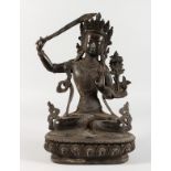 A THAI CAST METAL SEATED DEITY, holding a sword in her right hand. 12ins high.