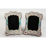 A PAIR OF ART NOUVEAU STYLE SILVER AND ENAMEL PHOTOGRAPH FRAMES. 8.5ins high.