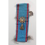 A BLUE SASH WITH CREST.