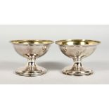 A GOOD PAIR OF GEORGE III SILVER CIRCULAR PEDESTAL SALTS with silver gilt bowls. London 1792.