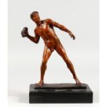A PATINATED BRONZE FIGURE, male nude throwing a rock, on a marble base. 12ins high.