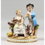 A GOOD 19TH CENTURY MEISSEN PORCELAIN GROUP, a young boy and a girl by his side with a goat, on an