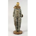 A LARGE GILT BRONZE PIERROT carrying a mandolin on his back, on a circular base. 23ins