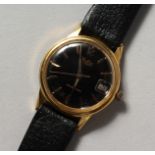 A GENTLEMAN'S MUDU WRISTWATCH with leather strap.