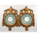 A GOOD PAIR OF SEVRES DESIGN CIRCULAR PLATES in pierced gilt frames, blue and gilt borders,