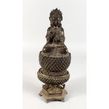 A CAST METAL EASTERN FEMALE DEITY, seated on a lotus base. 11ins high.