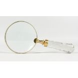 A MAGNIFYING GLASS with glass handle.