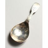 AN ENGRAVED FIDDLE PATTERN CADDY SPOON. Sheffield 1931.