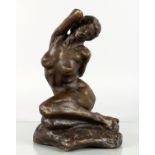 A BRONZE CASTING OF A SEATED FEMALE NUDE. 10.5ins high.