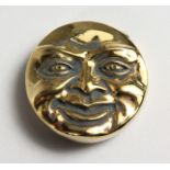 A BRASS DOUBLE SIDED MOON FACE VESTA.