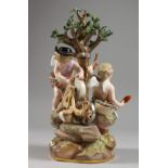 A MEISSEN PORCELAIN GROUP OF THE INFANT CUPID AND PSYCHE beneath a tree, cupid sharpening an