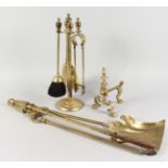 A BRASS FIRESIDE COMPANION SET ON STAND, set of three fireside tools, and a fire dog.