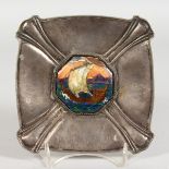 AN OMAR RAMSDEN SILVER DISH with enamel plaque, a boat in full sail. 6ins square.