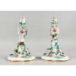 A GOOD PAIR OF MEISSEN FLOWER ENCRUSTED CANDLESTICKS with scrolls. Cross swords mark in blue. 9.5ins