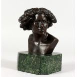 A SMALL BRONZE BUST OF A LADY, mounted on a marble base. 6ins high.