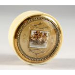 A GEORGIAN CIRCULAR IVORY PILL BOX with floral top. 2ins diameter.