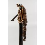 A RARE TRIBAL CARVED WOOD AND METAL WEAPON. 23ins long.