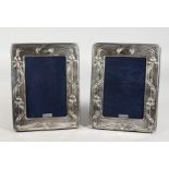 A PAIR OF ART NOUVEAU STYLE SILVER PHOTOGRAPH FRAMES. 7.5ins high.