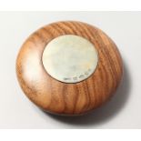 A LINLEY POLISHED WOOD WEIGHT with silver tablet. 4ins diameter.