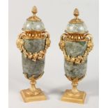 A PAIR OF LOUIS XVITH MARBLE AND ORMOLU URNS AND COVERS with pineapple finials and fruiting vines.