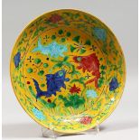 A CHINESE YELLOW GROUND PORCELAIN DISH decorated with fish. 9ins diameter.