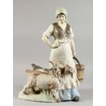 A LARGE AUSTRIAN POTTERY GROUP of a young girl with two goats. 21ins high.