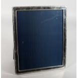 A SILVER PHOTOGRAPH FRAME with reeded edges. 11.5ins high x 9.5ins wide. London 1973.