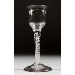 A GEORGIAN WINE GLASS with semi fluted bowl and white twist stem. 5.5ins high.