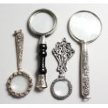 FOUR SILVER MAGNIFYING GLASSES.