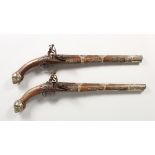 A PAIR OF EARLY 18TH CENTURY TURKISH SILVER MOUNTED FLINTLOCK PISTOLS, steel barrels and walnut