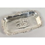A SILVER PIN TRAY repousse with cupids.