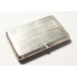 A RUSSIAN SILVER CIGARETTE CASE, with ribbed decoration. 4ins x 2.5INS.