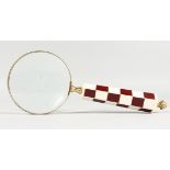 A MAGNIFYING GLASS with checked handle.
