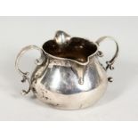 A GEORGE II SILVER TWIN HANDLED BRANDY WARMER. London 1736. Maker I. G. 4.5ins wide.