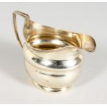 A GEORGE III SILVER MILK JUG with reeded edge and handle. London 1806. Maker Andrew Fogelberg.