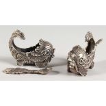 A PAIR OF SILVER DOLPHIN SALTS AND SPOON.