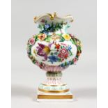 A GOOD 19TH CENTURY MEISSEN FLOWER ENCRUSTED URN painted with flowers on a square base. Crossed