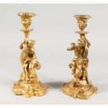 A PAIR OF LOUIS XVITH GILDED METAL CLASSICAL CANDLESTICKS of a nude female and a young boy on a