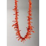 A CORAL NECKLACE with gold clasp.